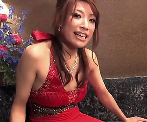 Hot babe in a gown enjoys a drink by herself