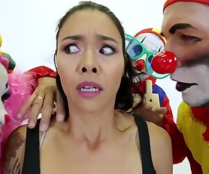 Cheeky and crazy tattooed lady fucked at the same time with three clowns.