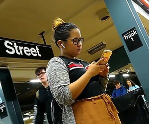 Cute chubby Filipina girl with glasses waiting for train