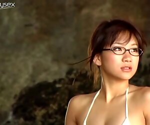 Giggling chick Ami Tokito stands under the water stream and looks sexy